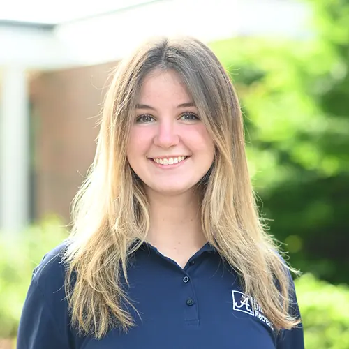 Smiling young woman wearing a navy blue