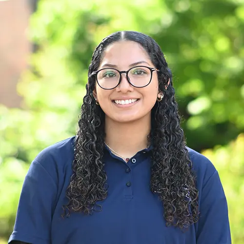 Smiling young woman wearing a navy blue